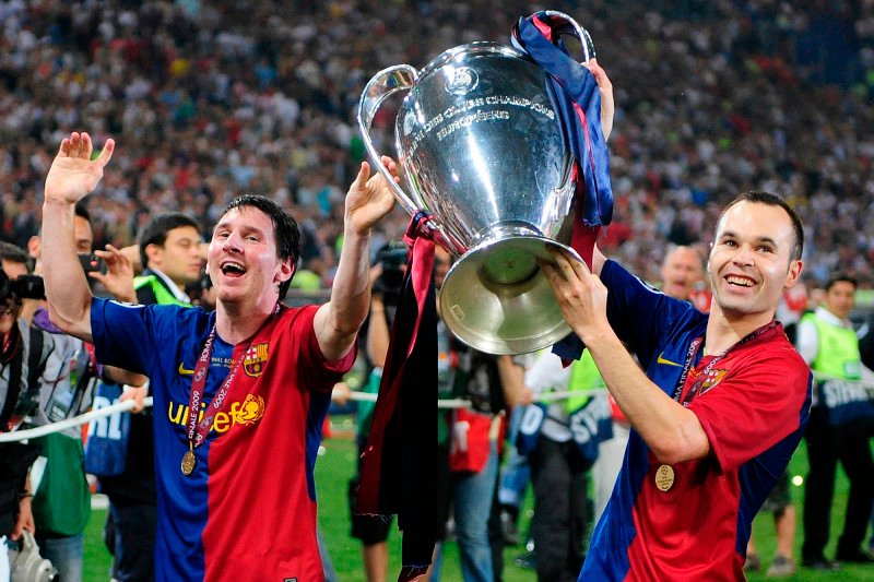 Lionel Messi and Andres Iniseta with the UEFA Champions League trophy after defeating Manchester United